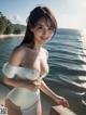 A woman in a white bathing suit posing by the water.