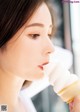 A woman is eating an ice cream cone. 